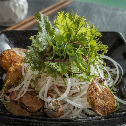Mushrooms in breadcrumbs with rice noodles and frisée salad