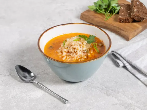 Pickle soup with tomato paste and pearl barley