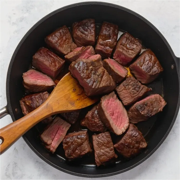 Sear the beef in vegetable oil until browned to seal in the juices and give the dish a rich flavor.
