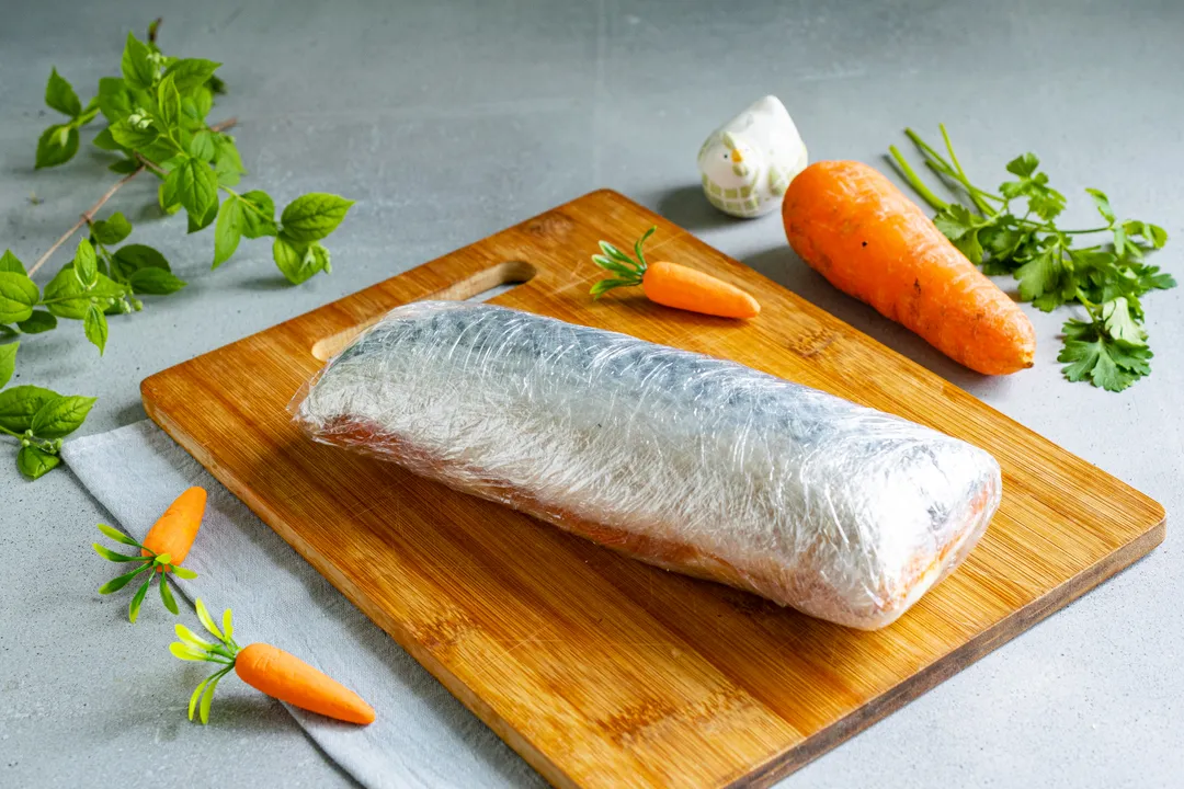 Tightly wrap the fish with egg and carrots in several layers of plastic wrap.
