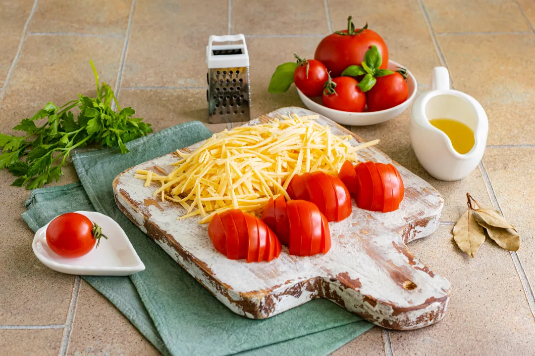 <p>Wash small tomatoes, cut into thin half-rings. Grate hard cheese on a grater with a large blade.</p>