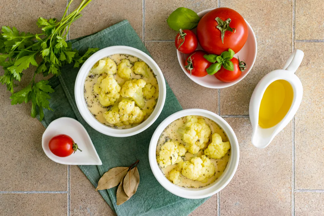 <p>Pour 2/3 of the cream and egg mixture over the vegetables. During cooking, the beaten eggs will increase in volume and completely cover the cauliflower florets.</p>