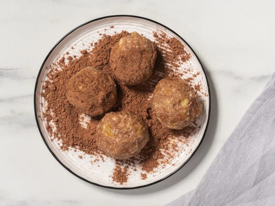Form small balls from the obtained mixture, shaping them like "Kartoshka" cakes.