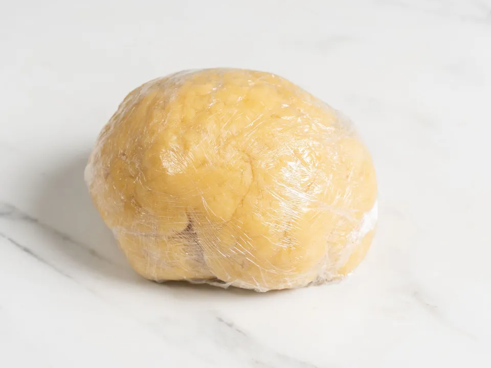 Lightly flour your work surface and turn out the dough. Continue kneading it for at least 10 minutes. The finished dough should be resilient enough that an indentation remains when pressed with a finger.