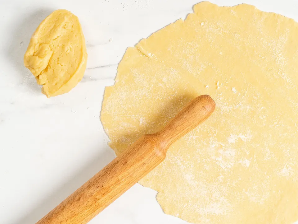 Divide the dough into 3-4 equal portions. Take one portion, and cover the remaining ones with a light towel, setting them aside to prevent them from drying out.