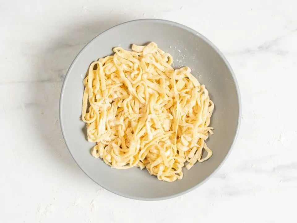 Transfer the homemade egg noodles to a container or deep bowl and cover with a lid. Store the noodles in the refrigerator. If you wish to store them longer, you can freeze them: spread the noodles on a sheet, freeze them, then transfer them to a bag and return them to the freezer.