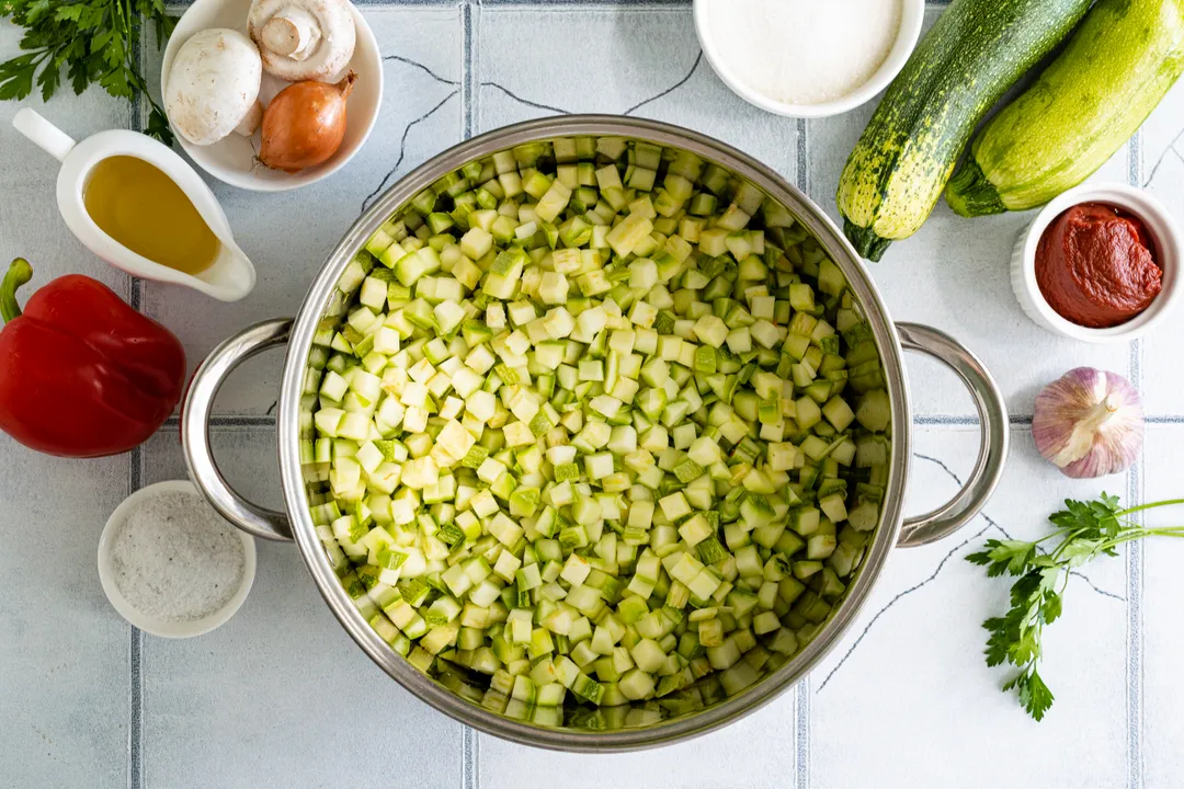 Wash the zucchini, trim the ends, and dice the vegetables into medium-sized cubes. Add the chopped zucchini to the pot with the other vegetables.