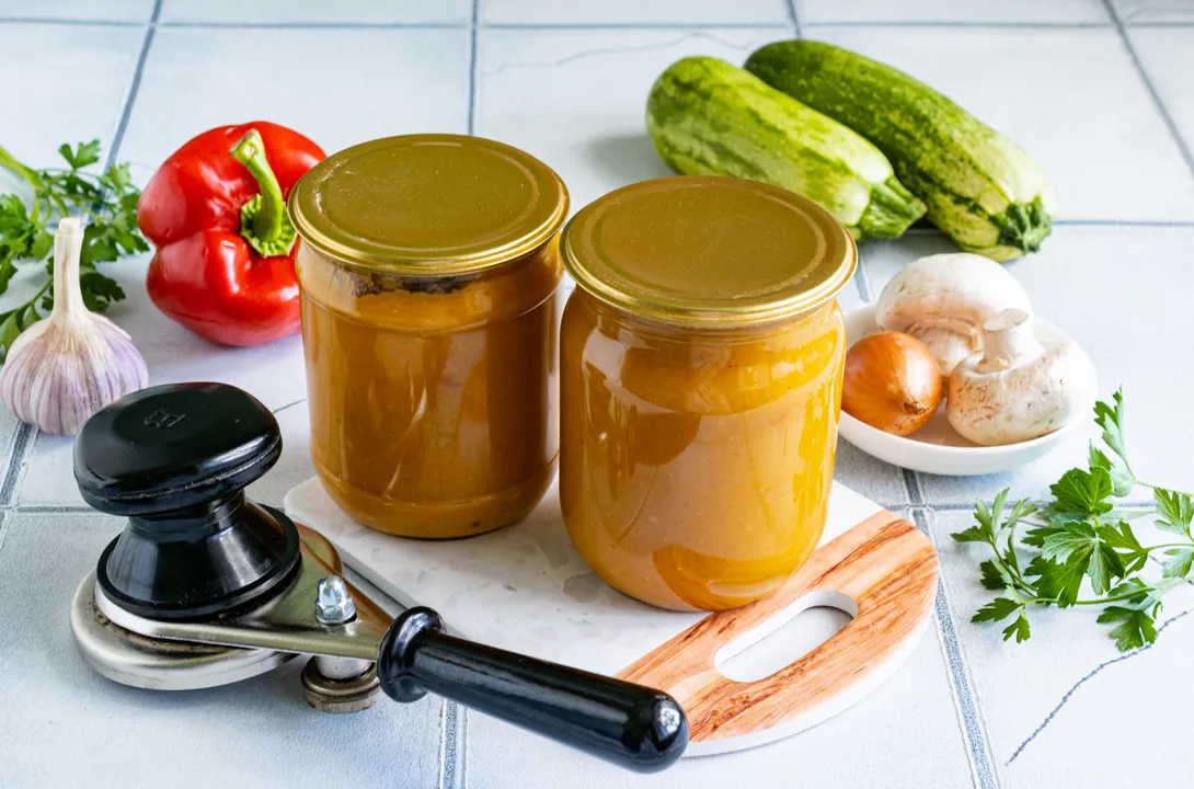 Carefully spoon the prepared zucchini caviar into dry, sterilized jars and seal them with a canning machine. Invert the jars of preserves, wrap them in a blanket, and leave them for 1-2 days until completely cool.