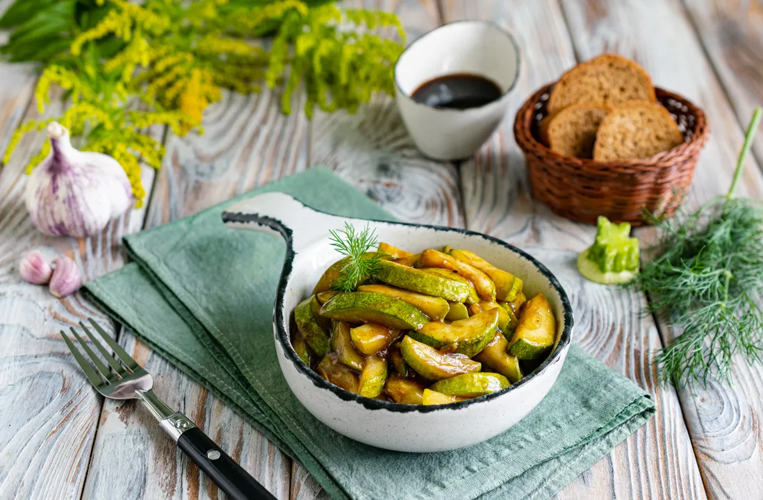 Garnish the finished dish with chopped dill. Serve the zucchini fried with soy sauce and garlic immediately after cooking, or chill them in the refrigerator beforehand.