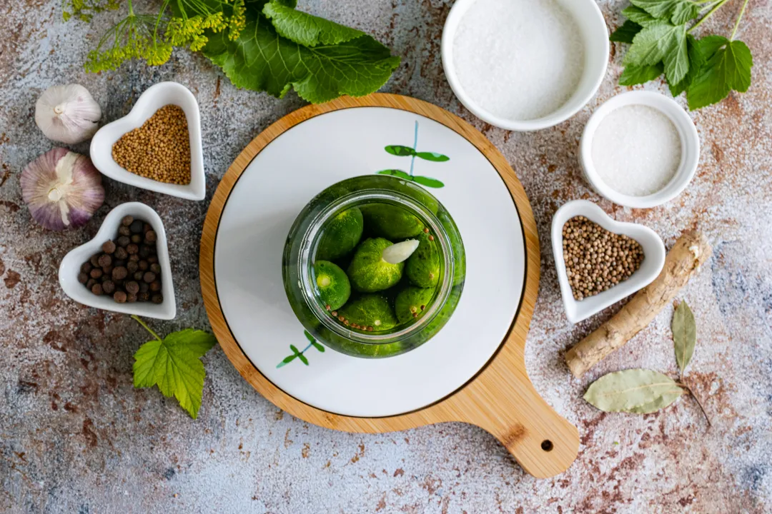 Bring 3 liters of water to a boil. Pour the boiling water over the cucumbers in jars. Cover the jars with lids (do not seal!), wrap them in a terry towel, and leave for 30 minutes to allow the vegetables to infuse.