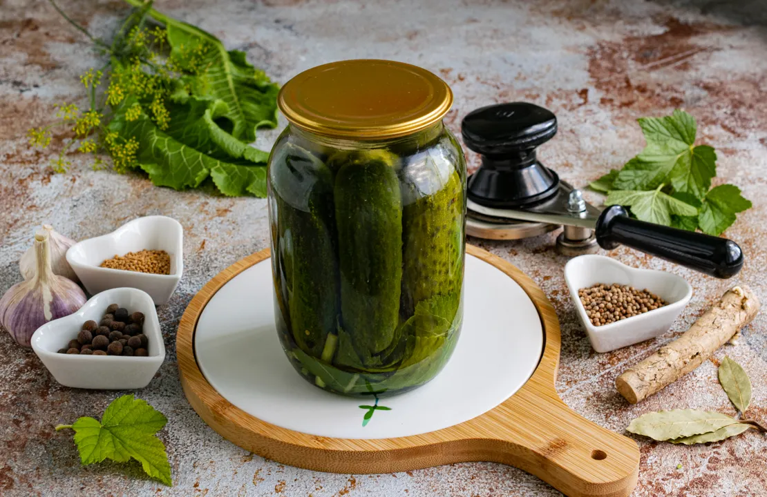Fill the jars with cucumbers with the prepared marinade. Cover them with sterilized metal lids and seal them with a seaming machine.