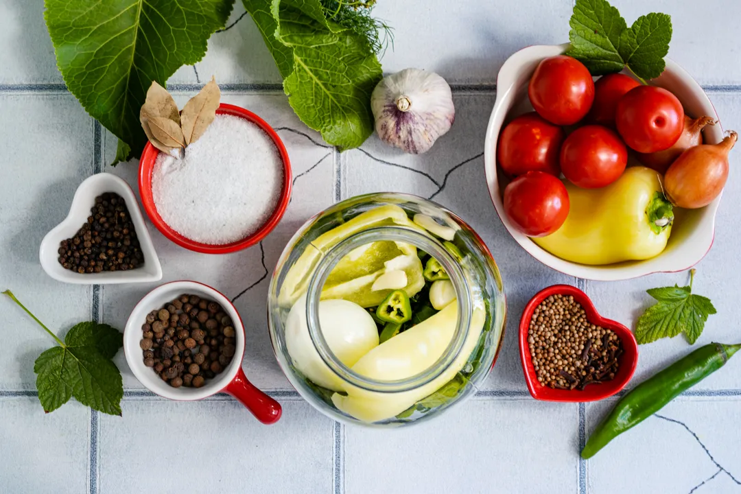 Place 1 onion, 1 sweet pepper, 2 cloves of garlic, and 2 rings of hot pepper into each jar.