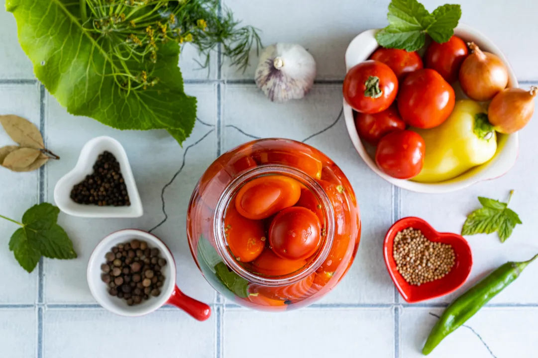 Pour boiling marinade over the vegetables in the jars. Cover them with sterilized metal lids (do not seal!), wrap them in a blanket, and leave for 20 minutes.
